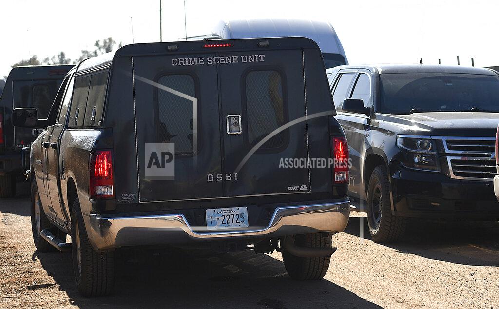 Billy Hefton Oklahoma Bureau of Investigation crime scene unit vehicle sits at the scene near Lacey, Okla., in Kingfisher County, Monday, Nov. 21, 2022, where four people were killed. State police in Oklahoma say that four people killed at a marijuana farm were "executed," and that they were Chinese citizens. (Billy Hefton/The Enid News & Eagle via AP)