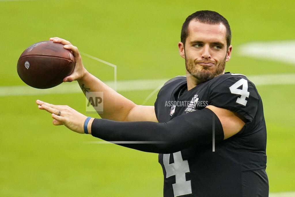 John Locher Las Vegas Raiders quarterback Derek Carr (4) throws a pass during an NFL football training camp practice Friday, Aug. 28, 2020, in Las Vegas. (AP Photo/John Locher)
