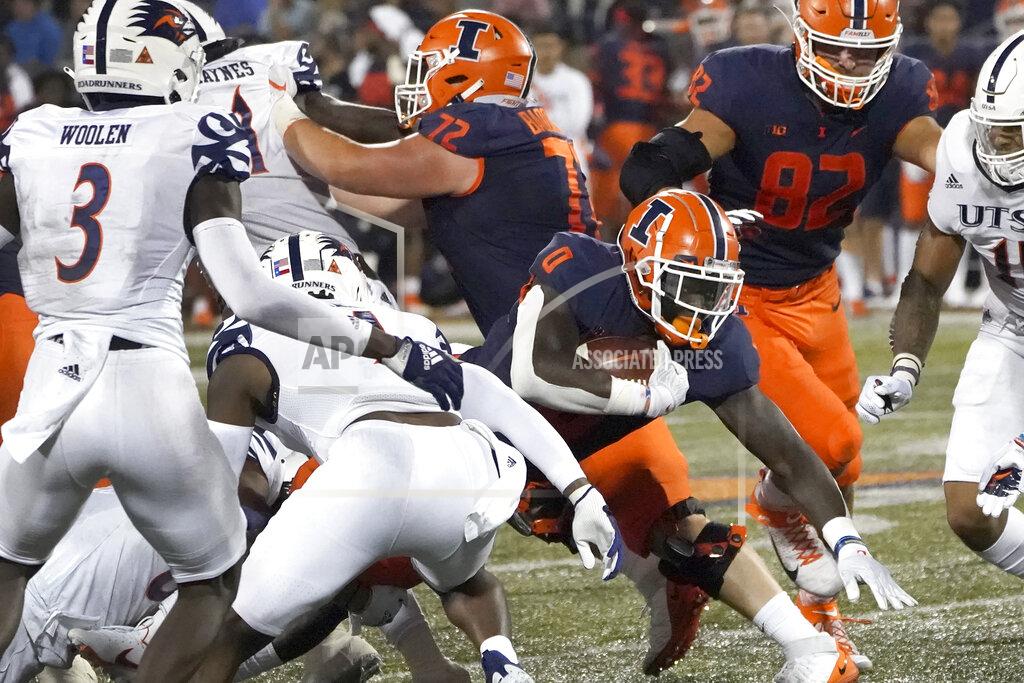Charles Rex Arbogast Illinois running back Joshua McCray (0) carries the ball through the UTSA defensive line during the first half of an NCAA college football game Saturday, Sept. 4, 2021, in Champaign, Ill. (AP Photo/Charles Rex Arbogast)