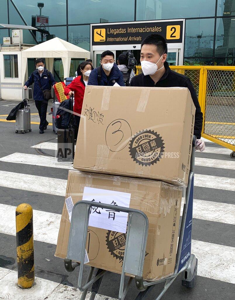 Cesar Barreto A member of a Chinese medical delegation pushes boxes of vaccines upon arrival to Jorge Chavez airport in Lima, Peru, Wednesday, Sept. 2, 2020. Experimental vaccines for the new coronavirus from the Chinese pharmaceutical company Sinopharm arrived to be injected into people as part of the third phase of a clinical trial, according to China’s Ambassador to Peru, Liang Yu. (AP Photo/Cesar Barreto)