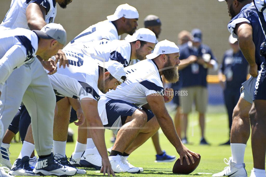 FILE - In this July 27, 2019, file photo, Dallas Cowboys center Travis Frederick readies to snap the ball at the NFL football team's training camp in Oxnard, Calif. Guillain-Barré syndrome, an autoimmune disease that attacks the nervous system, sapped most of Frederick’s strength and left him struggling to walk when the Cowboys returned from camp in California last summer. Ultimately, the diagnosis wasn’t early enough to save his season. Frederick missed all 18 games last season. (AP Photo/Michael Owen Baker, File)