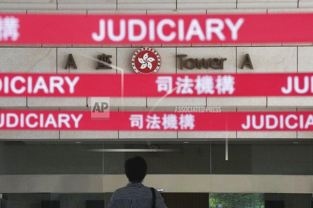 Vincent Yu A man walks toward the main entrance to local court in Hong Kong Thursday, July 22, 2021. Hong Kong police charged two top editors and two editorial writers at Apple Daily with collusion weeks after the city's largest pro-democracy newspaper was forced to cease publication and its assets were frozen. All four were charged with conspiring to "collude with a foreign country or with external elements to endanger national security" under the city's year-old national security law and appeared in court Thursday. (AP Photo/Vincent Yu)