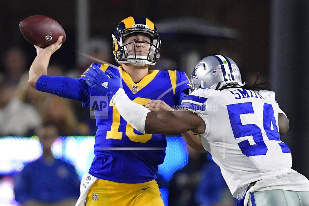 Mark J. Terrill Los Angeles Rams quarterback Jared Goff passes under pressure from Dallas Cowboys middle linebacker Jaylon Smith during the first half in an NFL divisional football playoff game Saturday, Jan. 12, 2019, in Los Angeles. (AP Photo/Mark J. Terrill)