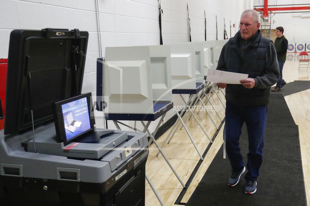 Tork Mason Mark Spear makes his way to the voting machine after filling out his ballot during a special election for Wisconsin's 7th Congressional District on Tuesday, May 12, 2020, at Wausau East High School in Wausau, Wis. Republican Tom Tiffany and Democrat Tricia Zunker are vying to fill the vacancy left by Republican Sean Duffy, who resigned from the seat in September. (Tork Mason/The Post-Crescent via AP)
