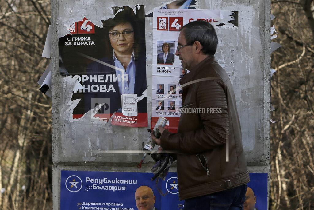 Valentina Petrova A man walks by a poster of Bulgarian Socialists' Party leader Kornelia Ninova in Sofia, Bulgaria, Wednesday, March 31, 2021. After months of nationwide anti-government protests over corruption, stalled reforms and a stagnating economy in the EU's poorest member state, Bulgarians are gearing up for a parliamentary election overshadowed by a deadly pandemic. (AP Photo/Valentina Petrova)