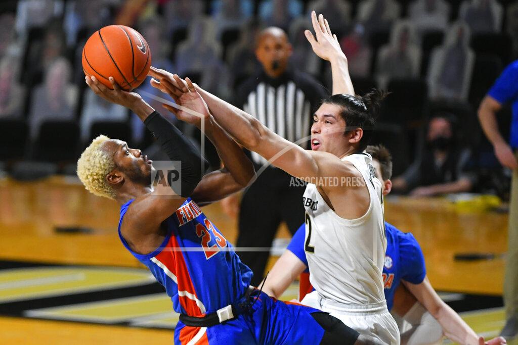John Amis Florida guard Scottie Lewis shoots as Vanderbilt forward Quentin Millora-Brown, right, defends during the second half of an NCAA college basketball game Wednesday, Dec. 30, 2020, in Nashville, Tenn. Florida won 91-72. (AP Photo/John Amis)
