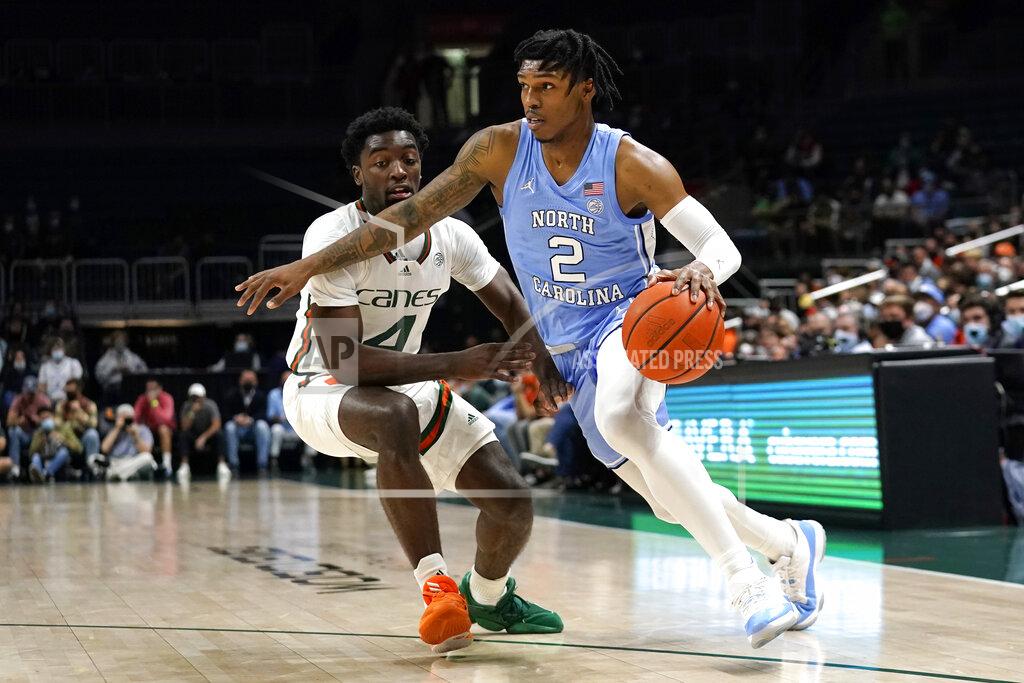 Lynne Sladky North Carolina guard Caleb Love (2) drives to the basket as Miami guard Bensley Joseph (4) defends during the first half of an NCAA college basketball game, Tuesday, Jan. 18, 2022, in Coral Gables, Fla. (AP Photo/Lynne Sladky)