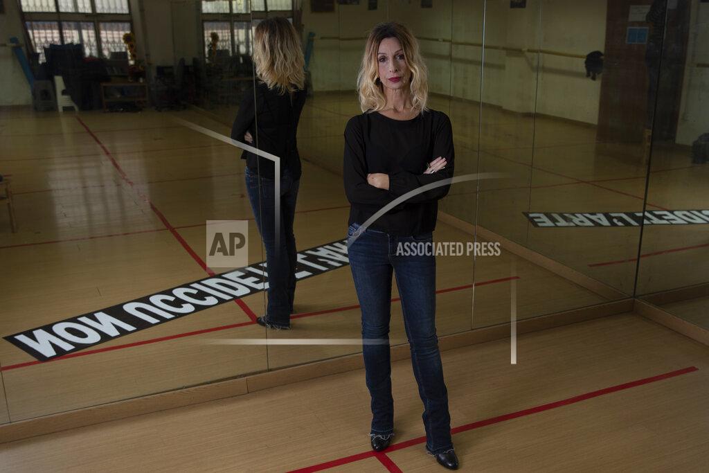 Alessandra Tarantino Manuela Verna, former dancer, teacher and artistic events promoter, poses for a portrait in her closed dance school, Friday, March 5, 2021. Reflected in a mirror is a near a banner reading "Don't kill arts". Her dance school is closed due to Covid-19 restrictions and she is struggling to hold some session on via internet. Worldwide, working women paid a high price during the pandemic as many quit jobs to care for children when schools closed. But Italy's women went into the crisis already struggling for decades to expand their presence in the national workforce. Among the 27 European Union nations, Italian women rank next to the bottom, after Greek women, in terms of percentage in national workforces. Among young women, Italians rank the lowest. (AP Photo/Alessandra Tarantino)