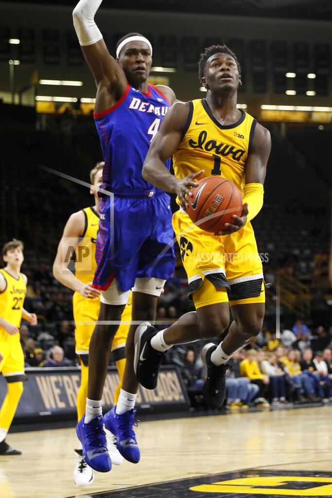 Charlie Neibergall Iowa guard Joe Toussaint drives to the basket ahead of DePaul forward Paul Reed (4) during the second half of an NCAA college basketball game, Monday, Nov. 11, 2019, in Iowa City, Iowa. DePaul won 93-78. (AP Photo/Charlie Neibergall)