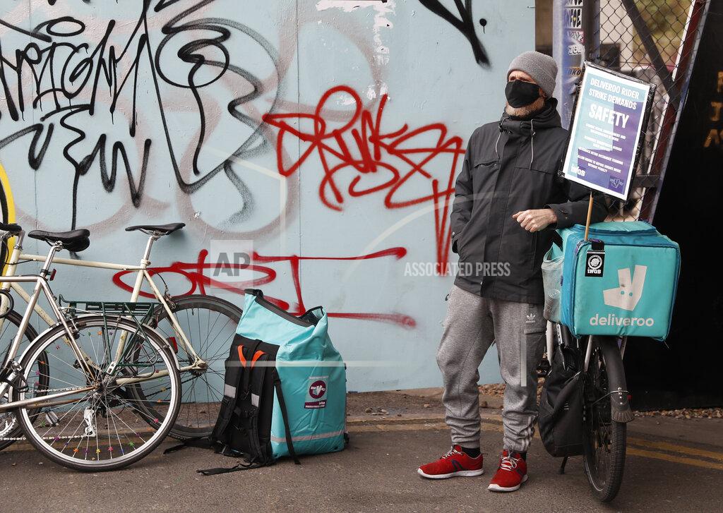 Alastair Grant Gig economy riders for app-based meal delivery platform Deliveroo demonstrate near the company headquarters in London, Wednesday, April 7, 2021. The strike coincides with the first day of unconditional trading for Deliveroo shares, which went public last week in a stock market offering.(AP Photo/Alastair Grant)