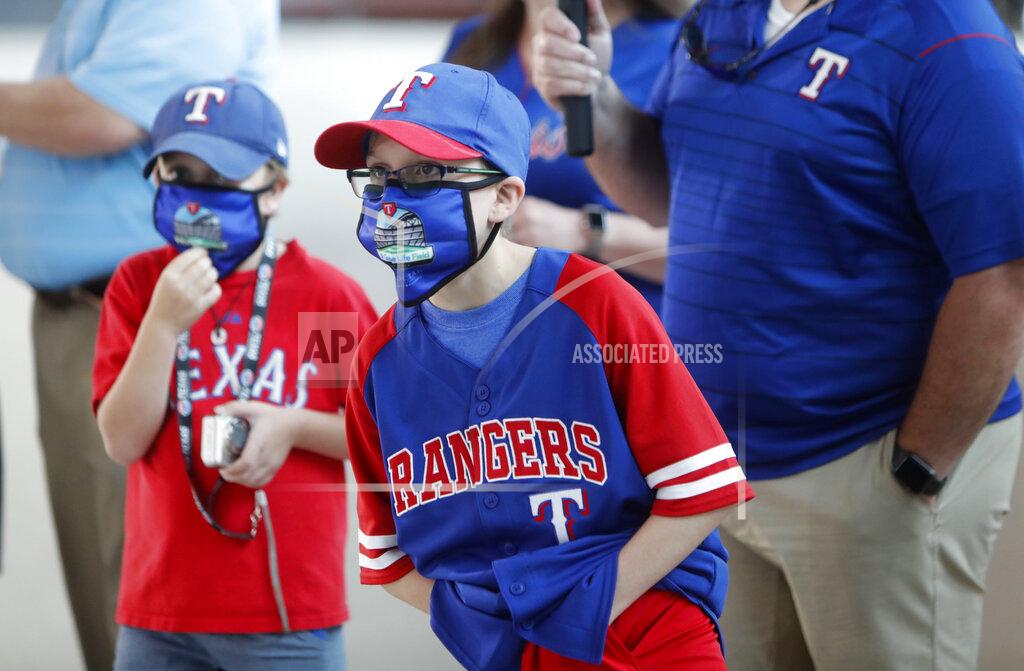 Lm Otero Gavin Bollmer, left, and his buddy, Austin LaFountain, wear masks as they tour Globe Life Field, home of the Texas Rangers baseball team, on the first day of public tours in Arlington, Texas, Monday, June 1, 2020. The robust TV experience available to sports fans has caused a decline in ticket sales for years, and now the coronavirus pandemic is forcing leagues to have games without them at all. But once they are allowed back in the stadium, ensuring fans are safe while also being entertained will be of paramount importance. (AP Photo/LM Otero, File)
