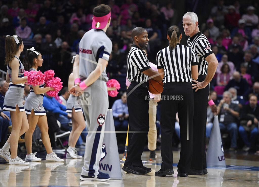 Jessica Hill Referee Bruce Morris, right, officiates an NCAA college basketball game between Connecticut and Temple with Eric Brewton, left, and Tiara Cruse, center,, Saturday, Feb. 9, 2019, in Storrs, Conn. Morris holds an NCAA record for the longest shot recorded.(AP Photo/Jessica Hill)