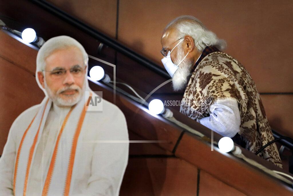 Manish Swarup FILE - In this Nov. 11 2020, file photo, Indian Prime Minister Narendra Modi leaves after a function at the Bharatiya Janata Party headquarters following a state election in New Delhi, India. Despite clear signs that India was being swamped by another surge of coronavirus infections, Modi refused to cancel campaign rallies, a major Hindu festival and cricket matches with spectators. The crisis has badly dented Modi’s carefully cultivated image as an able technocrat. (AP Photo/Manish Swarup, File)