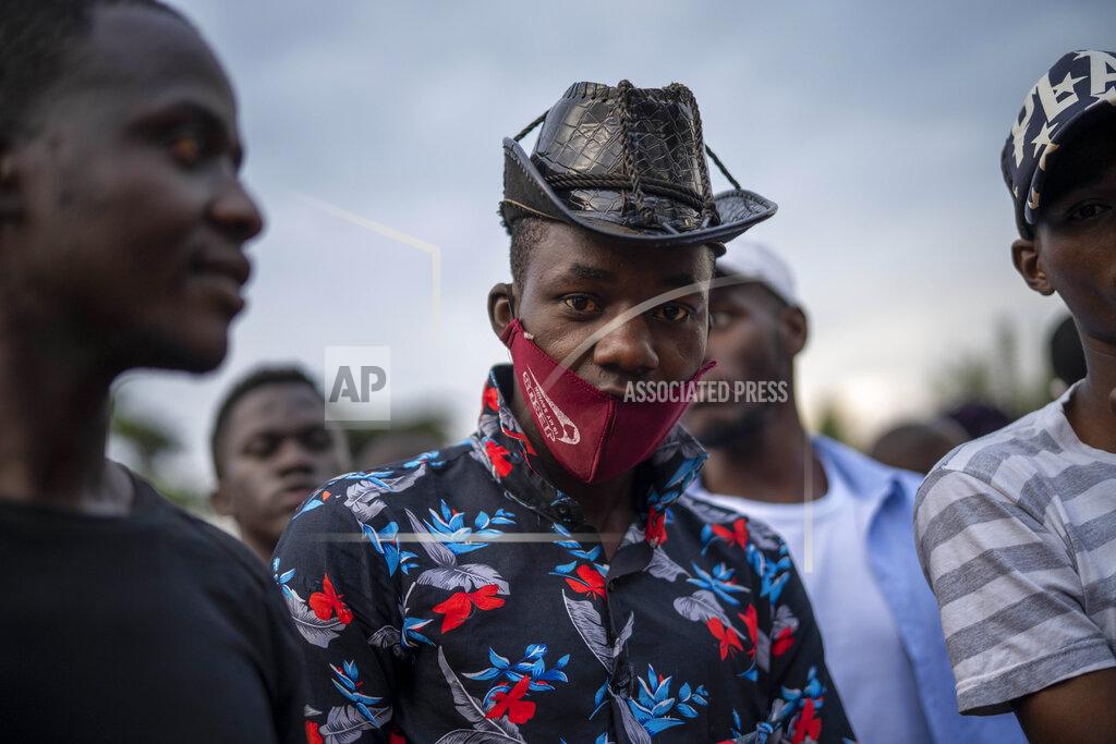 Jerome Delay Ugandans wait to vote in Kampala, Uganda, Thursday, Jan. 14, 2021. Ugandans are voting in a presidential election tainted by widespread violence that some fear could escalate as security forces try to stop supporters of leading opposition challenger BobiWine from monitoring polling stations.(AP Photo/Jerome Delay)