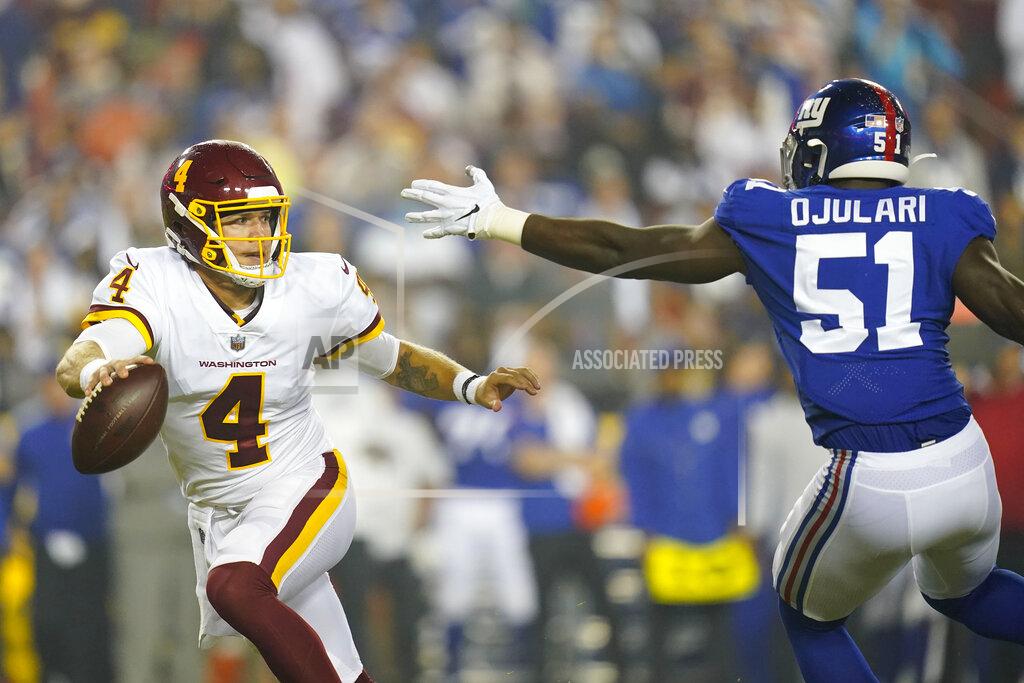 Patrick Semansky Washington Football Team quarterback Taylor Heinicke (4) runs to avoid being tackled by New York Giants linebacker Azeez Ojulari (51) during the first half of an NFL football game, Thursday, Sept. 16, 2021, in Landover, Md. (AP Photo/Patrick Semansky)