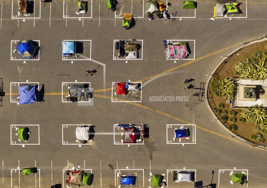 Noah Berger Rectangles designed to help prevent the spread of the coronavirus by encouraging social distancing line a city-sanctioned homeless encampment at San Francisco's Civic Center on May 21, 2020. (AP Photo/Noah Berger)