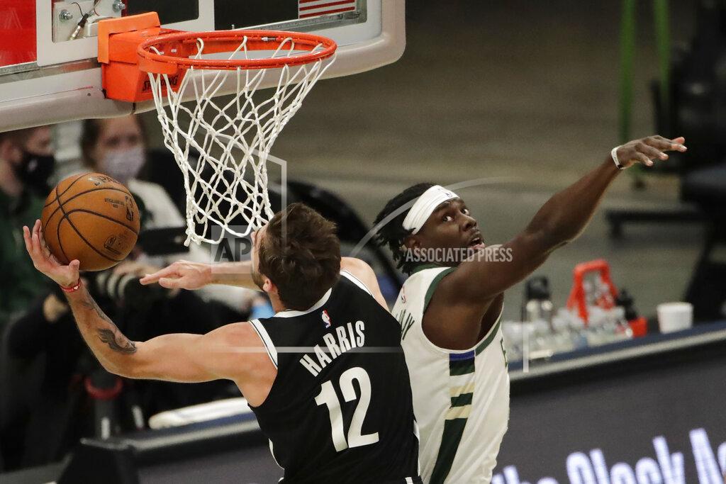 Aaron Gash Brooklyn Nets' Joe Harris (12) shoots past Milwaukee Bucks' Jrue Holiday during the first half of an NBA basketball game Tuesday, May 4, 2021, in Milwaukee. (AP Photo/Aaron Gash)