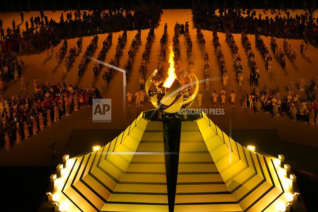 Lee Jin-Man The Olympic flame burns during the opening ceremony in the Olympic Stadium at the 2020 Summer Olympics, Friday, July 23, 2021, in Tokyo, Japan. (AP Photo/Lee Jin-man)