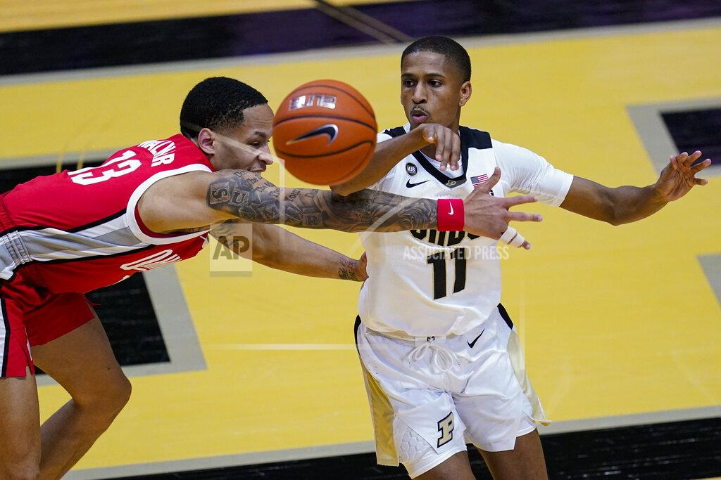 Michael Conroy Purdue guard Isaiah Thompson (11) makes a pass over Ohio State guard CJ Walker (13) during the second half of an NCAA college basketball game in West Lafayette, Ind., Wednesday, Dec. 16, 2020. (AP Photo/Michael Conroy)