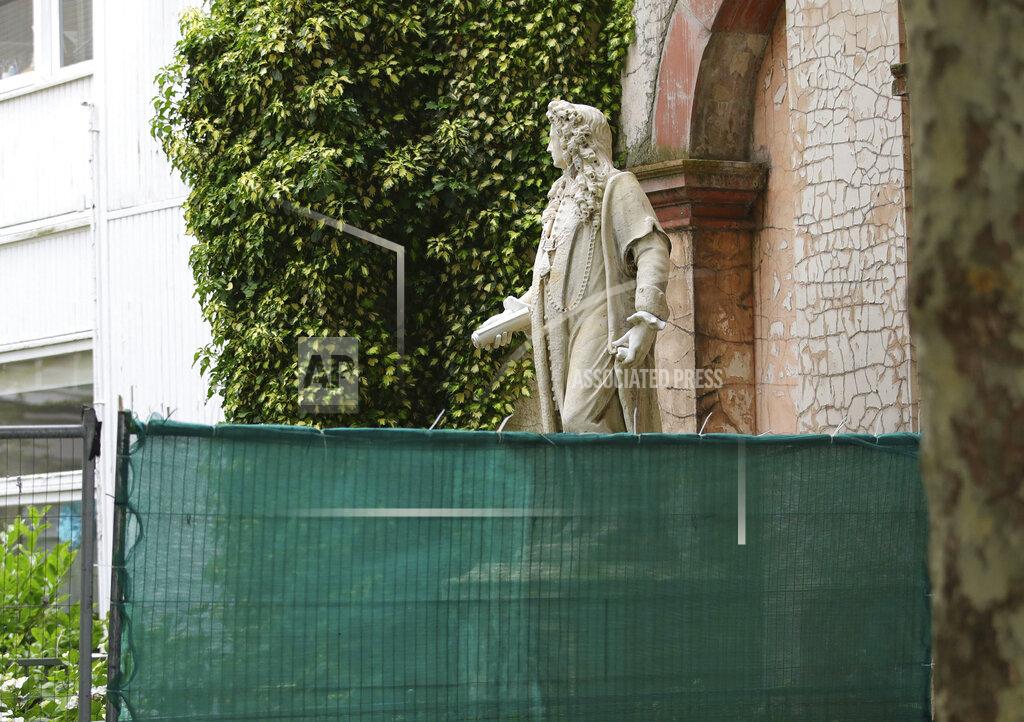 Aaron Chown Fencing is put up around a statue of Robert Clayton at the St. Thomas Hospital in, London, Friday, June 12, 2020, following Black Lives Matter protests that took place across the UK over the weekend. The protests were ignited by the death of George Floyd, who died after he was restrained by Minneapolis police on May 25. (Aaron Chown/PA via AP)