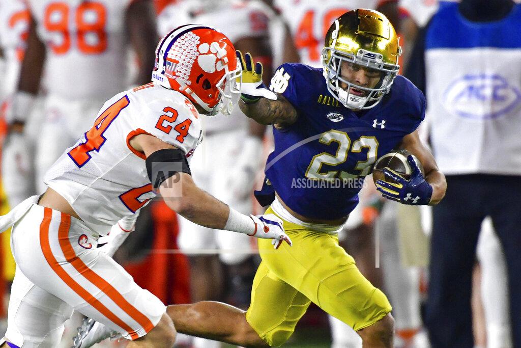 Matt Cashore Notre Dame running back Kyren Williams (23) fends off Clemson Tigers safety Nolan Turner (24) on his way to a touchdown during the first quarter of an NCAA college football game Saturday, Nov. 7, 2020, in South Bend, Ind. (Matt Cashore/Pool Photo via AP)