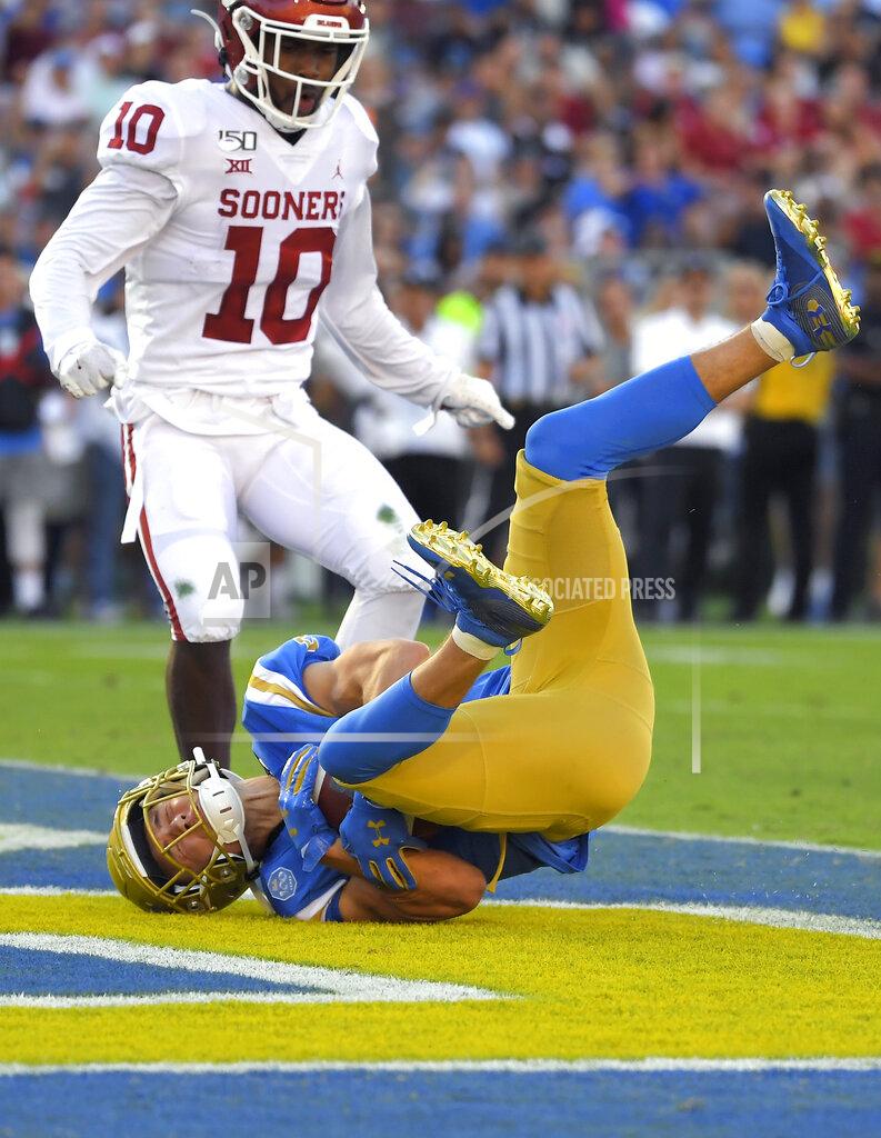 Mark J. Terrill UCLA wide receiver Kyle Philips, below, dives in for a touchdown as Oklahoma safety Pat Fields watches during the first half of an NCAA college football game Saturday, Sept. 14, 2019, in Pasadena, Calif. (AP Photo/Mark J. Terrill)