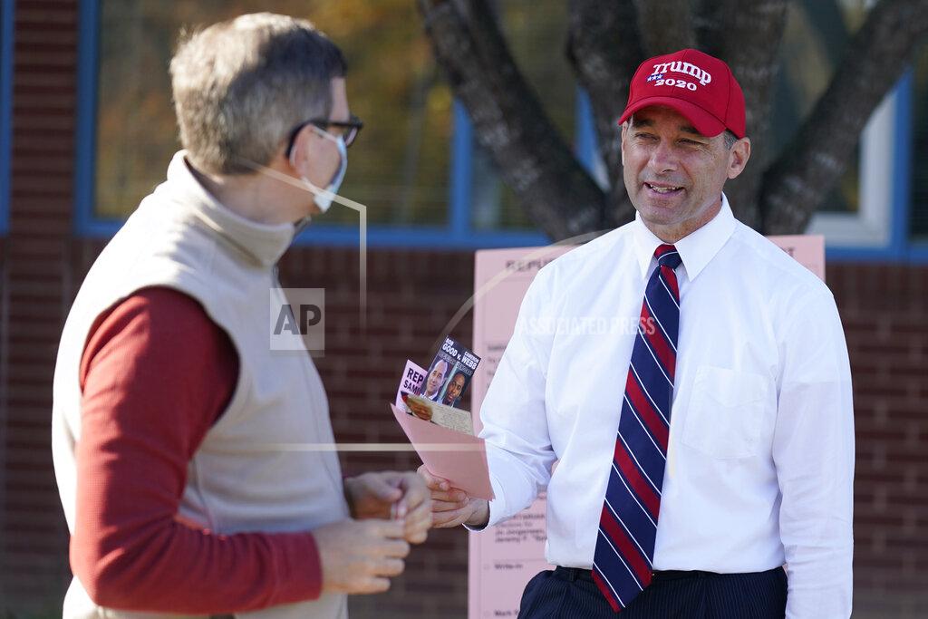 Steve Helber Republican Congressional candidate Bob Good, right, talks to a supporter at a polling place in Charlottesville, Va., Tuesday Nov. 3, 2020. Good is facing Democrat Cameron Webb in today's election. (AP Photo/Steve Helber)