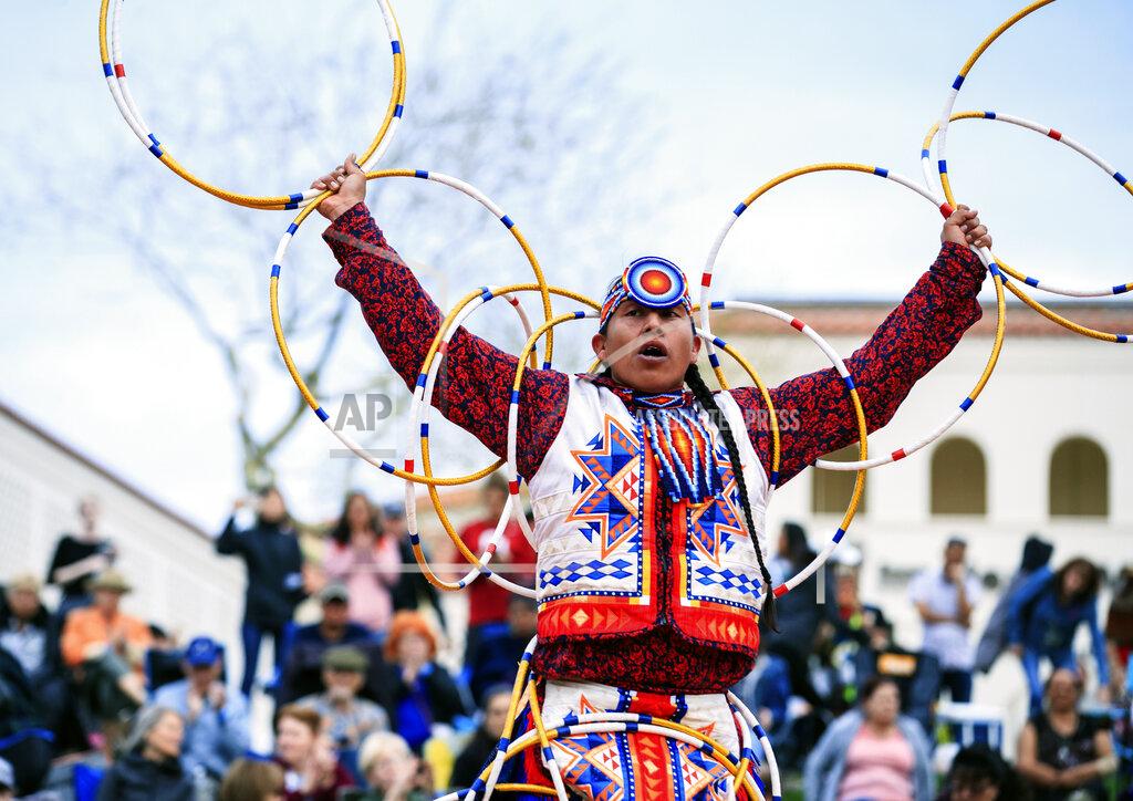 In this photo provided by the Heard Museum, Scott Sixkiller Sinquah, who is Gila River Pima, Hopi, Cherokee and Choctaw, performs at the annual Heard Museum World Championship Hoop Dance Contest in Phoenix, Feb. 9, 2020. Hoop dancing has rarely ever been about competition for the world champion Sinquah. He does it to pay homage to traditional healing aspects of the dancing the style is known for. He also dances for his fellow dancers and that friendly connection that's been missing since the pandemic hit. (Jared Platt/Heard Museum via AP)