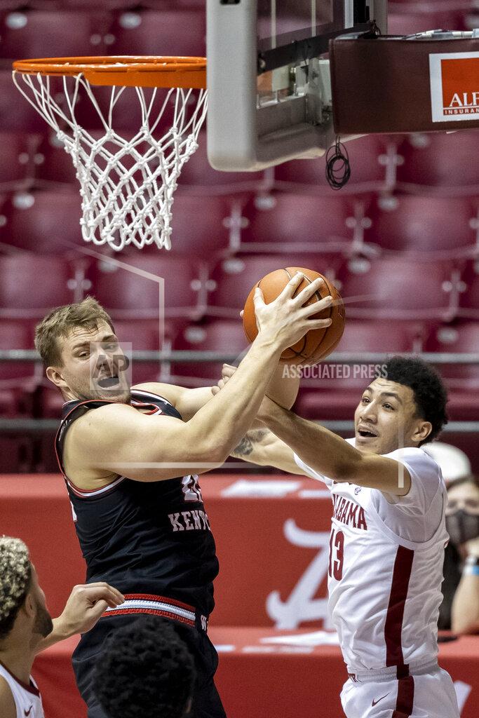 Vasha Hunt Western Kentucky forward Carson Williams (22) grabs rebound under pressure from Alabama guard Jahvon Quinerly (13) during the first half of an NCAA college basketball game, Saturday, Dec. 19, 2020, in Tuscaloosa, Ala. (AP Photo/Vasha Hunt)