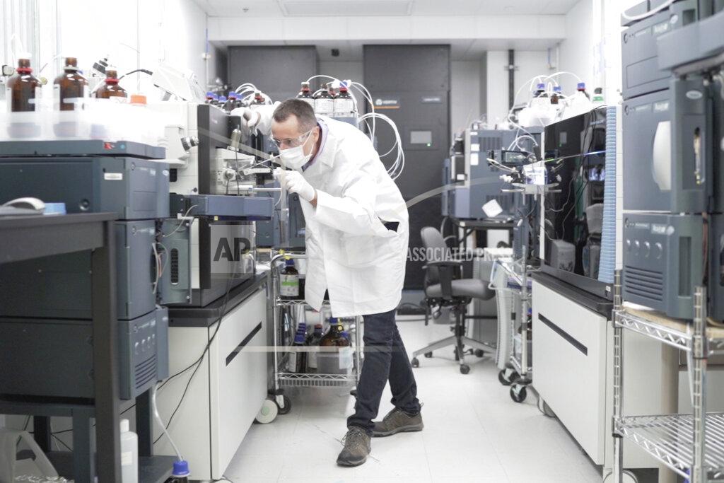 Huy Mach In this image from video provided by Washington University, researcher Nicolas Barthelemy works on a p-tau217 test for Alzheimer's disease at a laboratory in St. Louis, Mo., on Monday, July 27, 2020. Several companies and universities have developed versions of these tests, which look for a form of tau protein, one of the substances that can build up and damage the brains of people with Alzheimer’s. (Huy Mach/University of Washington via AP)