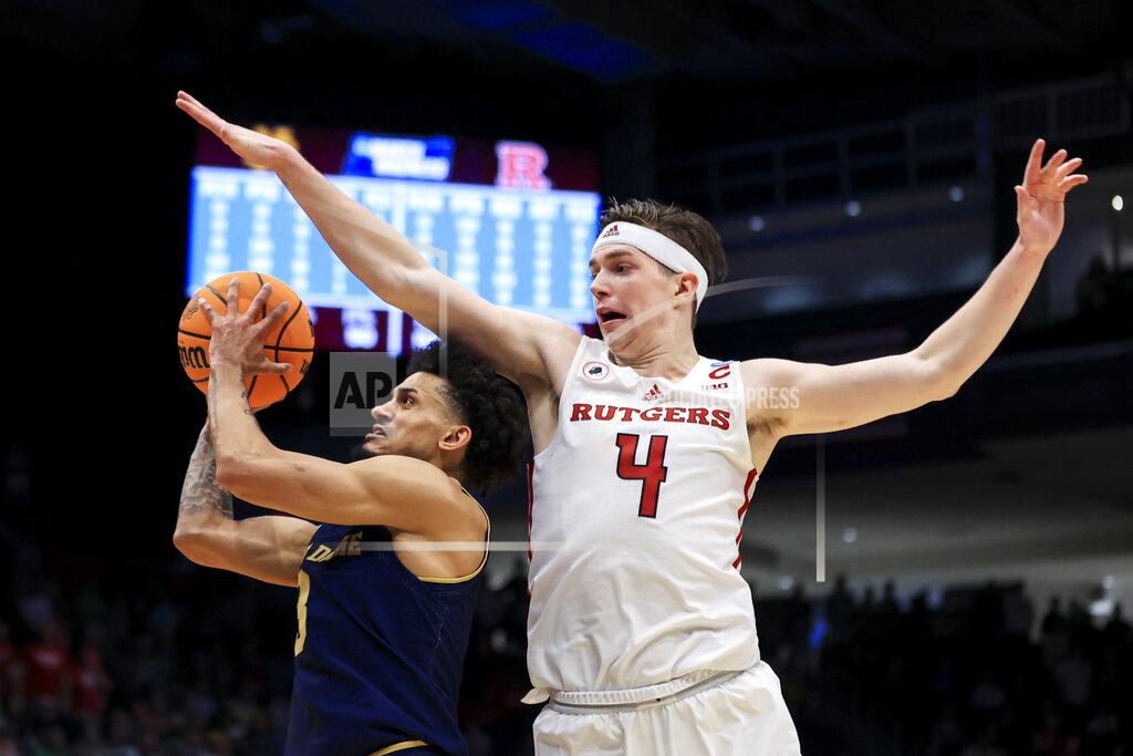 Aaron Doster Notre Dame's Prentiss Hubb, left, drives to the basket against Rutgers' Paul Mulcahy during the second overtime of a First Four game in the NCAA men's college basketball tournament Wednesday, March 16, 2022, in Dayton, Ohio. Notre Dame won 89-87 in double overtime. (AP Photo/Aaron Doster)