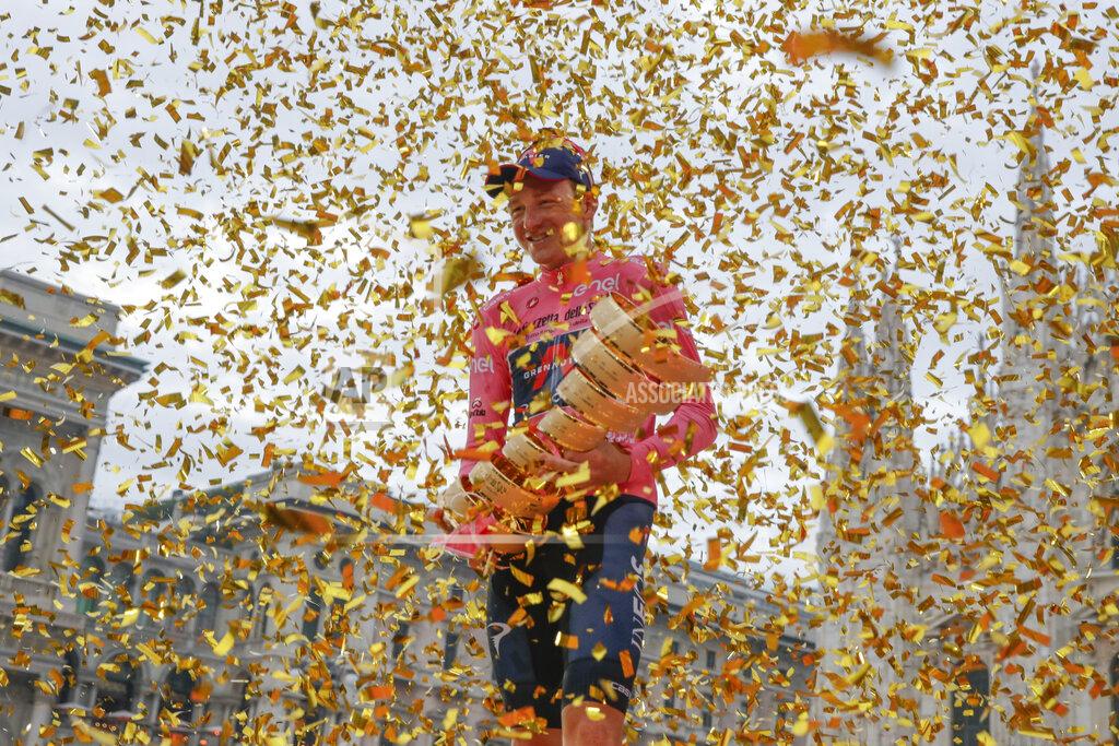 Luca Bruno Britain's Tao Geoghegan Hart holds the trophy after winning the Giro d'Italia cycling race, in Milan, Italy, Sunday, Oct. 25, 2020. In one of the most exciting final stages of a Grand Tour, British rider Tao Geoghegan Hart won the Giro d’Italia on Sunday, edging out Australian Jai Hindley by just 39 seconds. (AP Photo/Luca Bruno)