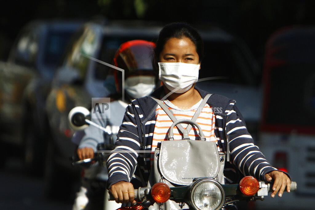 Heng Sinith Cambodian school girls wear face masks as they drive their motorbikes back home at the end of their school outside Phnom Penh, Cambodia, Wednesday, Feb. 3, 2021. (AP Photo/Heng Sinith)