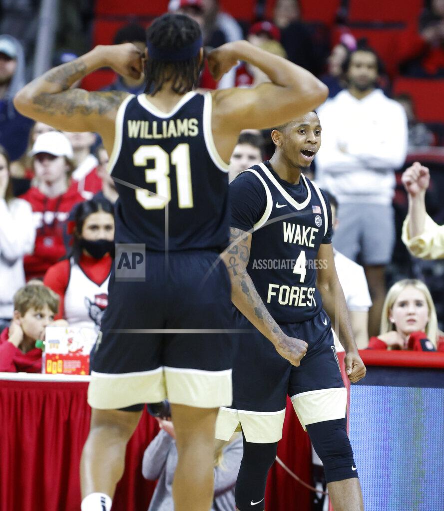 Ethan Hyman Wake Forest's Daivien Williamson (4) and Alondes Williams (31) celebrate after Williamson made a basket while being fouled during the second half of an NCAA college basketball game against North Carolina State in Raleigh, N.C., Wednesday, Feb. 9, 2022. (Ethan Hyman/The News & Observer via AP)