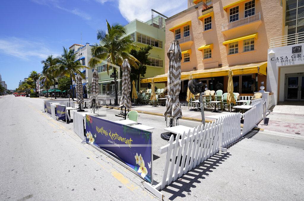 Wilfredo Lee Empty outdoor seating for a restaurant and closed hotels are shown, Tuesday, Aug. 11, 2020, in Miami Beach, Florida's famed Ocean Drive on South Beach. Florida added 276 fatalities to its coronavirus death toll on Tuesday, a new state record. (AP Photo/Wilfredo Lee)