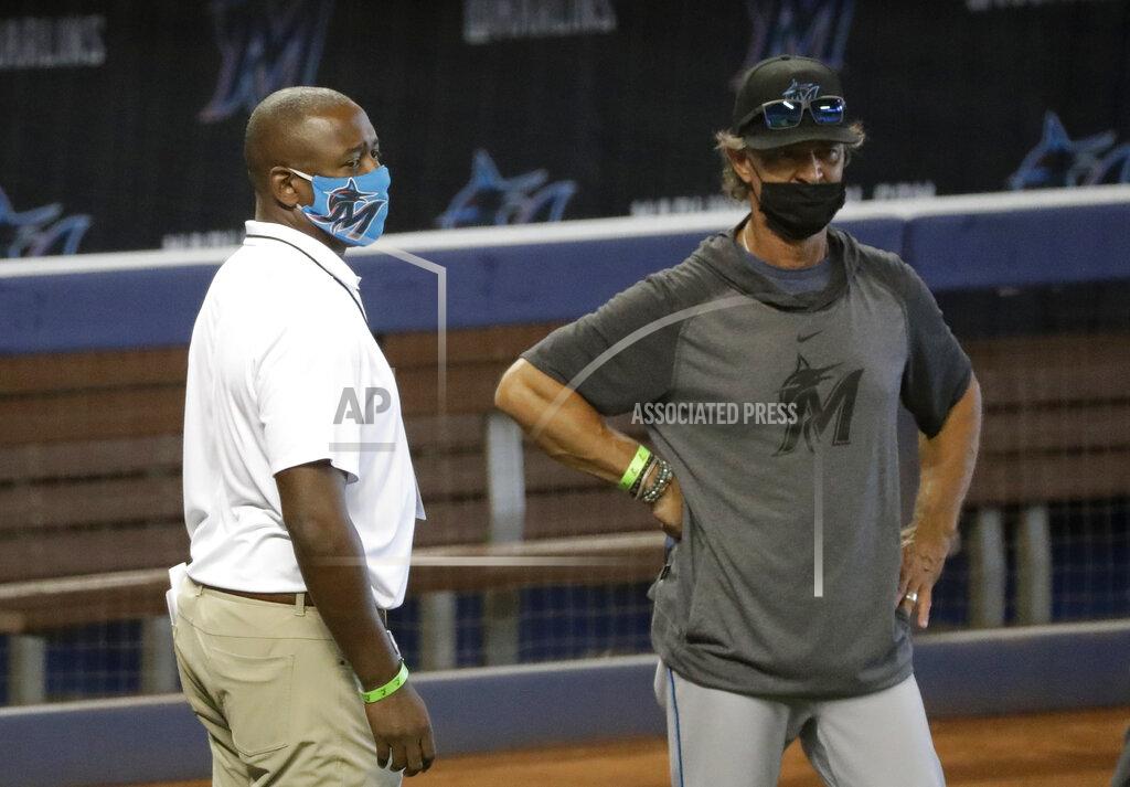 Wilfredo Lee Miami Marlins president of baseball operations Michael Hill, left, talks with manager Don Mattingly during a baseball workout at Marlins Park, Sunday, July 5, 2020, in Miami. (AP Photo/Wilfredo Lee)