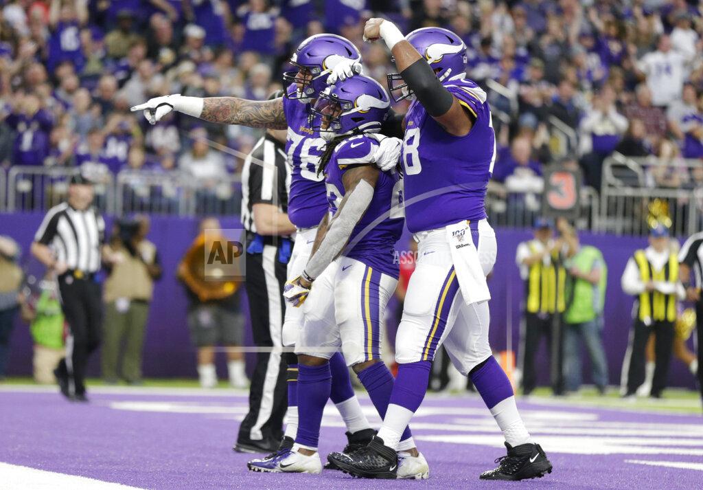Andy Clayton-King Minnesota Vikings running back Mike Boone, center, celebrates with teammates after scoring on a 1-yard touchdown run during the second half of an NFL football game against the Chicago Bears, Sunday, Dec. 29, 2019, in Minneapolis. (AP Photo/Andy Clayton-King)