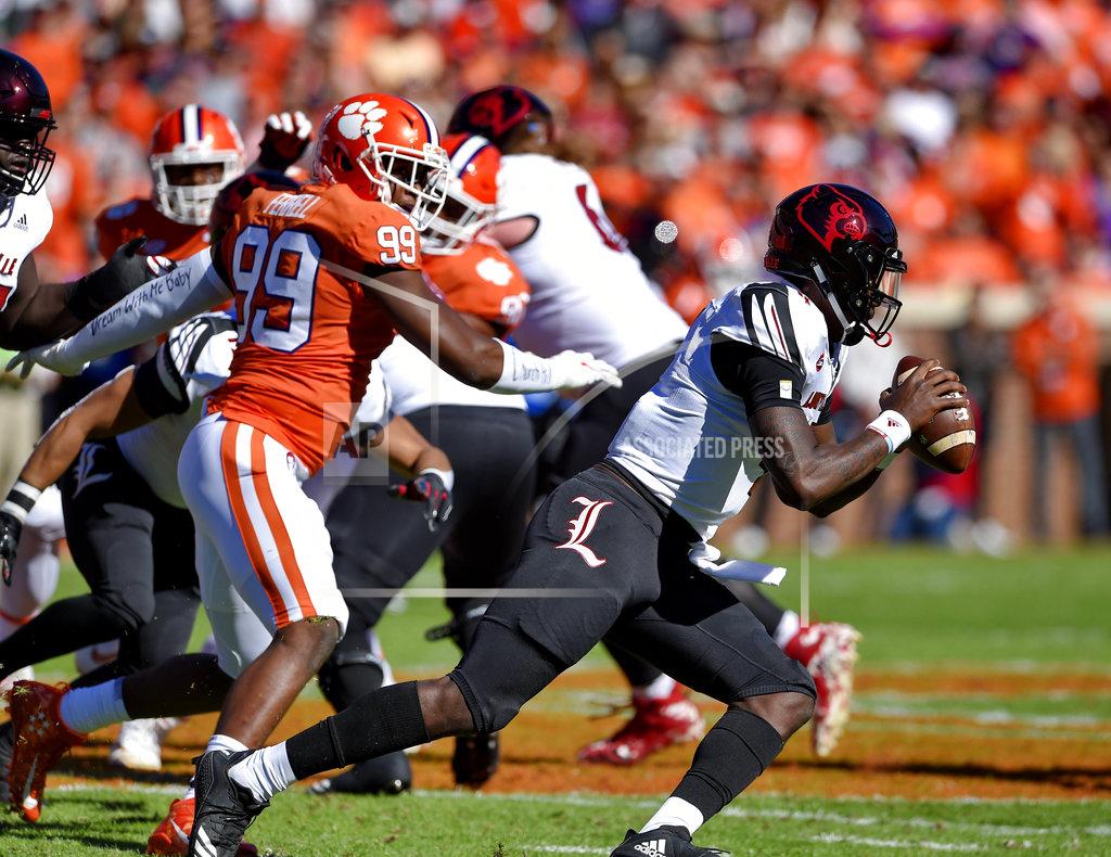 Richard Shiro Louisville quarterback Jawon Pass scrambles out of the pocket while pursued by Clemson's Clelin Ferrell (99) during the first half of an NCAA college football game Saturday, Nov. 3, 2018, in Clemson, S.C. (AP Photo/Richard Shiro)