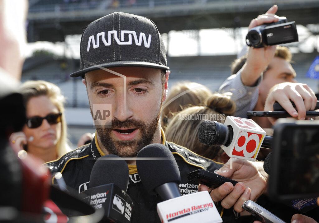 FILE - In this May 19, 2018, file photo, James Hinchcliffe, of Canada, talks with the media after failed to qualify for the Indianapolis 500 auto race, in Indianapolis. Chip Ganassi and Michael Andretti have joined Roger Penske in calling for guaranteed spots in the Indianapolis 500. The team owners argue their financial commitment to IndyCar is too steep to afford missing out on the biggest race of the year. (AP Photo/Darron Cummings, File)