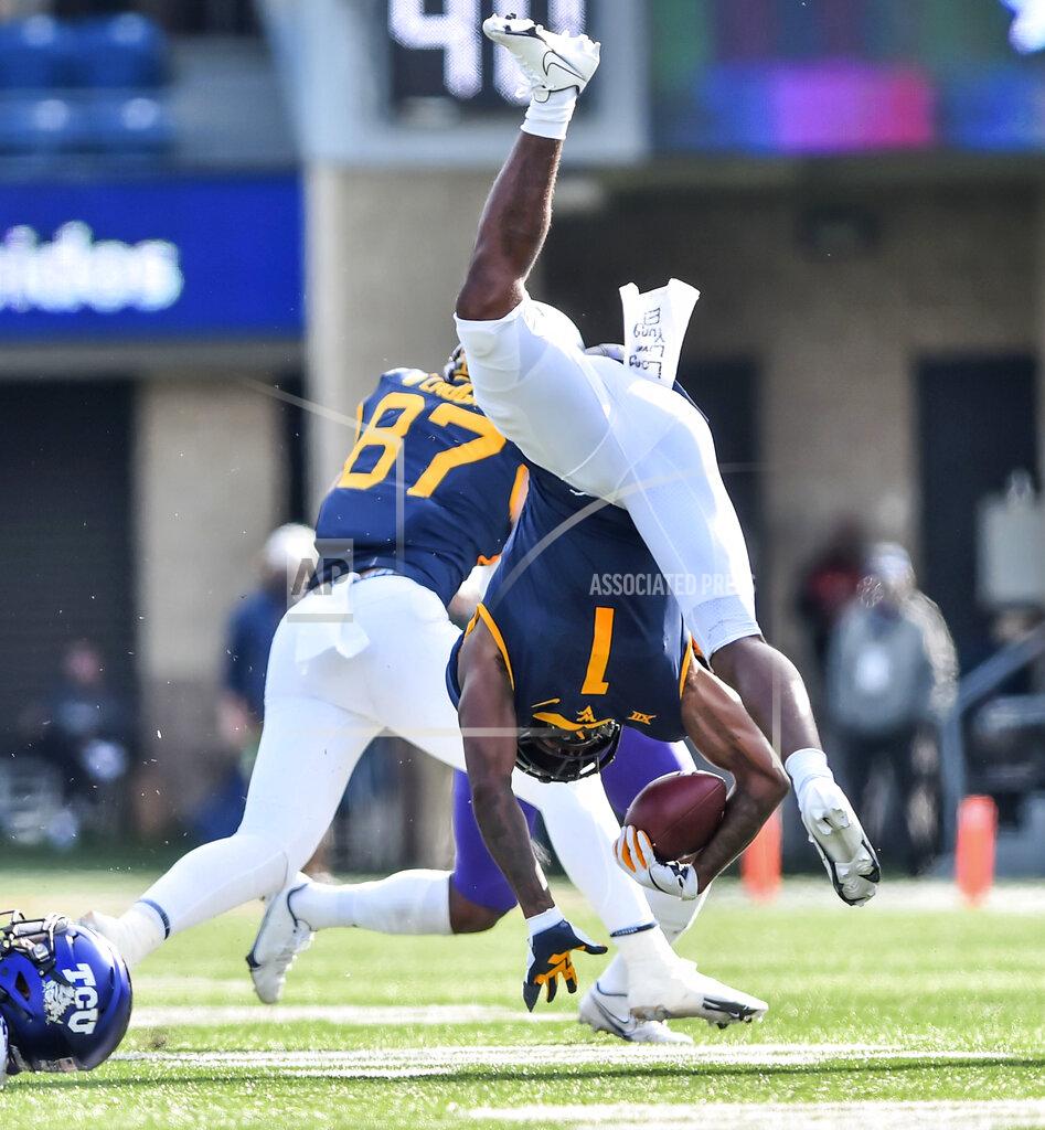William Wotring West Virginia wide receiver T.J. Simmons (1) is tackled by TCU safety Ar'Darius Washington (24) during the first half of an NCAA college football game on Saturday, Nov. 14, 2020, in Morgantown, W.Va. (William Wotring/The Dominion-Post via AP)