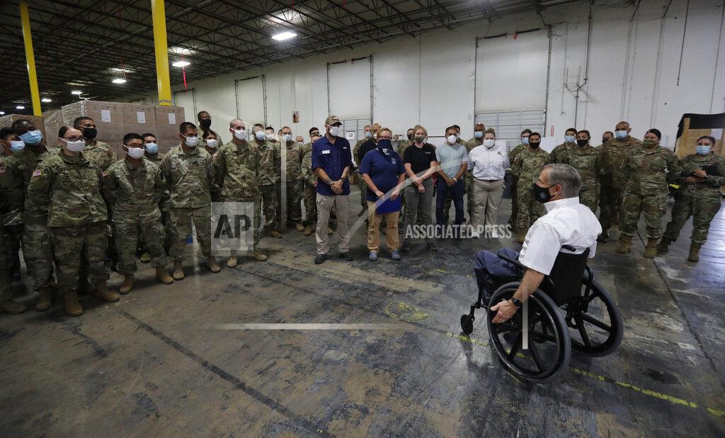 Eric Gay Texas Gov. Greg Abbott, foreground, addresses members of the National Guard during a visit to a Texas Division of Emergency Management Warehouse filled with Personal Protective Equipment, Tuesday, Aug. 4, 2020, in San Antonio. (AP Photo/Eric Gay)