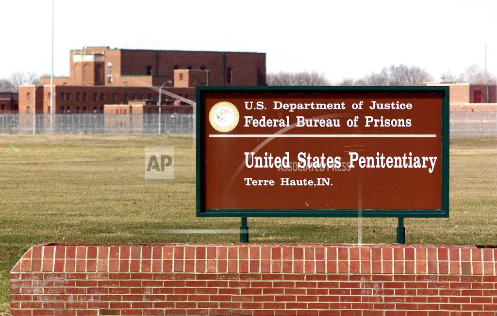 FILE - In this May 16, 2001, file photo, the entrance to the U.S. Penitentiary in Terre Haute, Ind. A Zen Buddhist priest wants a federal judge to stop the execution of a federal death row inmate he’s been counseling and argues he would be put at high risk for the coronavirus if the execution happens this month. Dale Hartkemeyer goes by the religious name Seigen. He filed a lawsuit Thursday in federal court in Indiana. The 68-year-old wants the court to delay Wesley Ira Purkey’s execution until a coronavirus vaccine is available or there’s a widespread effective treatment. Purkey is one of four federal death row inmates scheduled to be executed in July and August. (AP Photo/Michael Conroy, File)