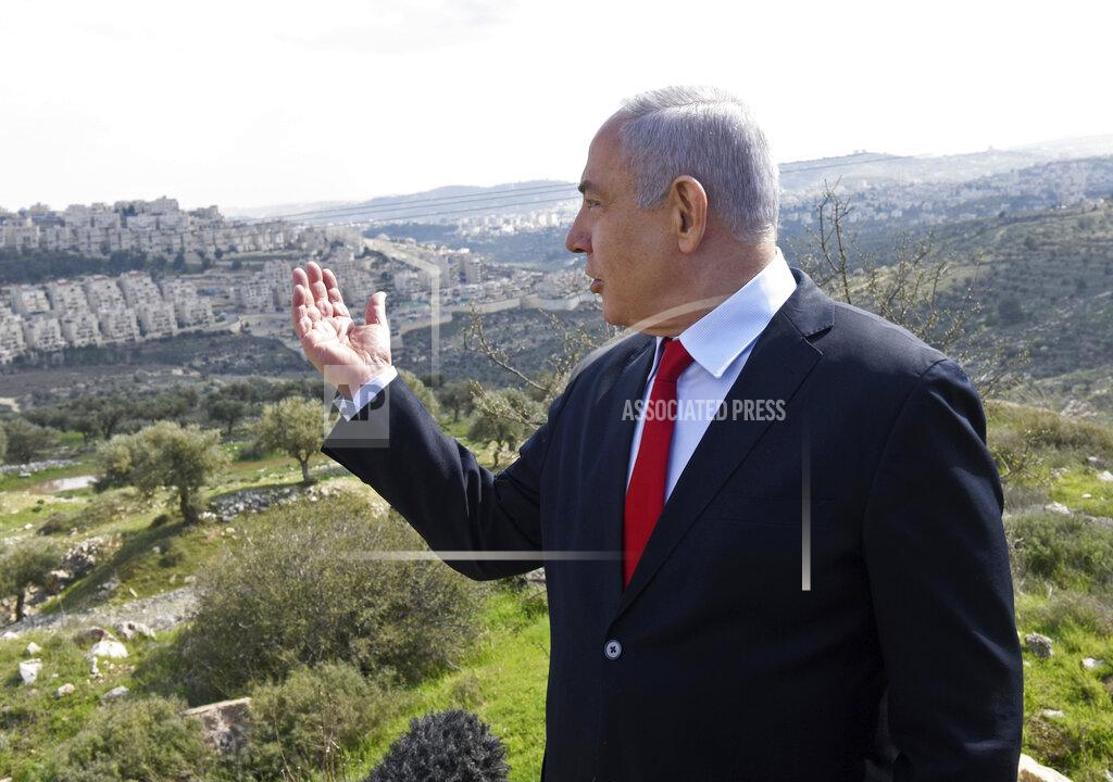 FILE - In this Feb. 20, 2020 file photo, Israeli Prime Minister Benjamin Netanyahu visits the area where a new neighborhood is to be built in the East Jerusalem settlement of Har Homa. A senior Emirati official warned Wednesday, June 17, 2020 that Israel's planned annexation of parts of the West Bank could lead Arab states to call for a single binational state for Israelis and Palestinians. (Debbie Hill/Pool Photo via AP, File)