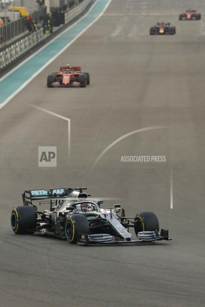 Hassan Ammar Mercedes driver Lewis Hamilton of Britain leads on Ferrari driver Charles Leclerc of Monaco during the Emirates Formula One Grand Prix, at the Yas Marina racetrack in Abu Dhabi, United Arab Emirates, Sunday, Dec.1, 2019. (AP Photo/Hassan Ammar)