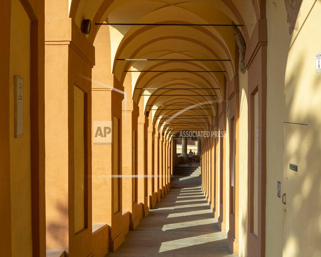 Guido Calamosca A view of the porticoes in Bologna, Italy, Wednesday, July 28, 2021. Bologna's 12th-century porticoes, still part of the city's everyday life, have been added to the World Heritage List. At a meeting in China on Wednesday, the World Heritage Committee of UNESCO, the U.N. culture agency, inscribed the porticoes on the prestigious list. The addition raises to 58 the number of Italian sites on the list. (Guido Calamosca/LaPresse via AP)