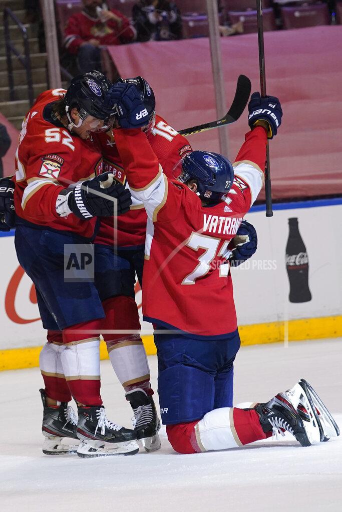 Marta Lavandier Florida Panthers defenseman MacKenzie Weegar (52) congratulates center Frank Vatrano (77) after Vatrano scored in overtime of the team's NHL hockey game against the Chicago Blackhawks, Tuesday, Jan. 19, 2021, in Sunrise. The Panthers won 5-4. (AP Photo/Marta Lavandier)