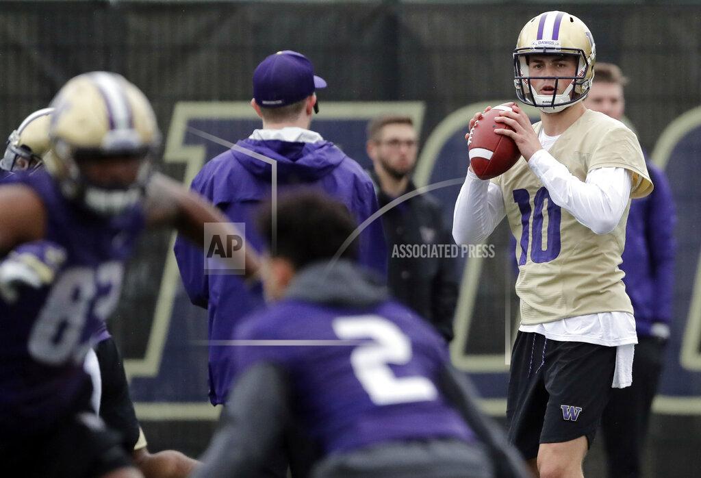 Ted S. Warren Washington quarterback Jacob Eason, right, looks to pass during the first day of spring NCAA college football practice, Wednesday, April 3, 2019, in Seattle. (AP Photo/Ted S. Warren)