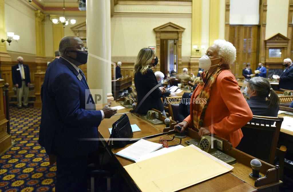 Hyosub Shin State Sens. Ed Harbison, left, D-Columbus, and Minority Leader Gloria Butler, D-Stone Mountain, confer inside the Senate Chambers during the second day of the 2021 legislative session at the Georgia State Capitol, Tuesday, Jan. 12, 2021, in Atlanta. (Hyosub Shin/Atlanta Journal-Constitution via AP)