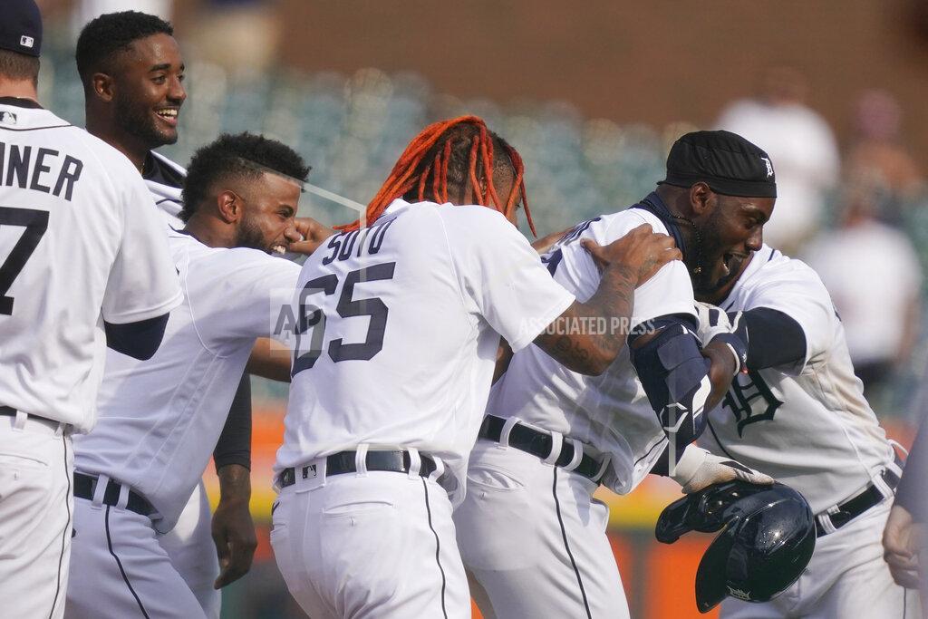 Carlos Osorio Detroit Tigers' Akil Baddoo, right, is swarmed by teammates after hitting the walk off game winning run during the tenth inning of a baseball game against the Minnesota Twins, Tuesday, April 6, 2021, in Detroit. (AP Photo/Carlos Osorio)