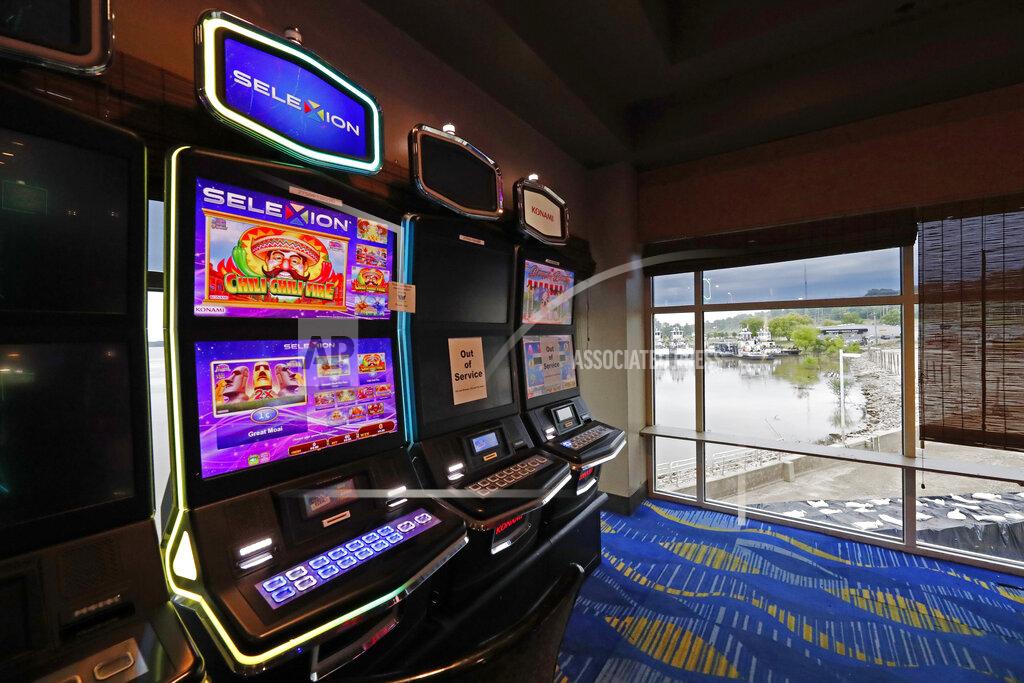 Rogelio V. Solis Two video slot machines await players while one in the middle sits out of service at the WaterView Casino and Hotel in Vicksburg, Miss., Thursday, May 21, 2020. Following a two-month shutdown due to coronavirus, casinos statewide are allowed to reopen Thursday, amid enhanced restrictions to keep customers and employees safe. (AP Photo/Rogelio V. Solis)